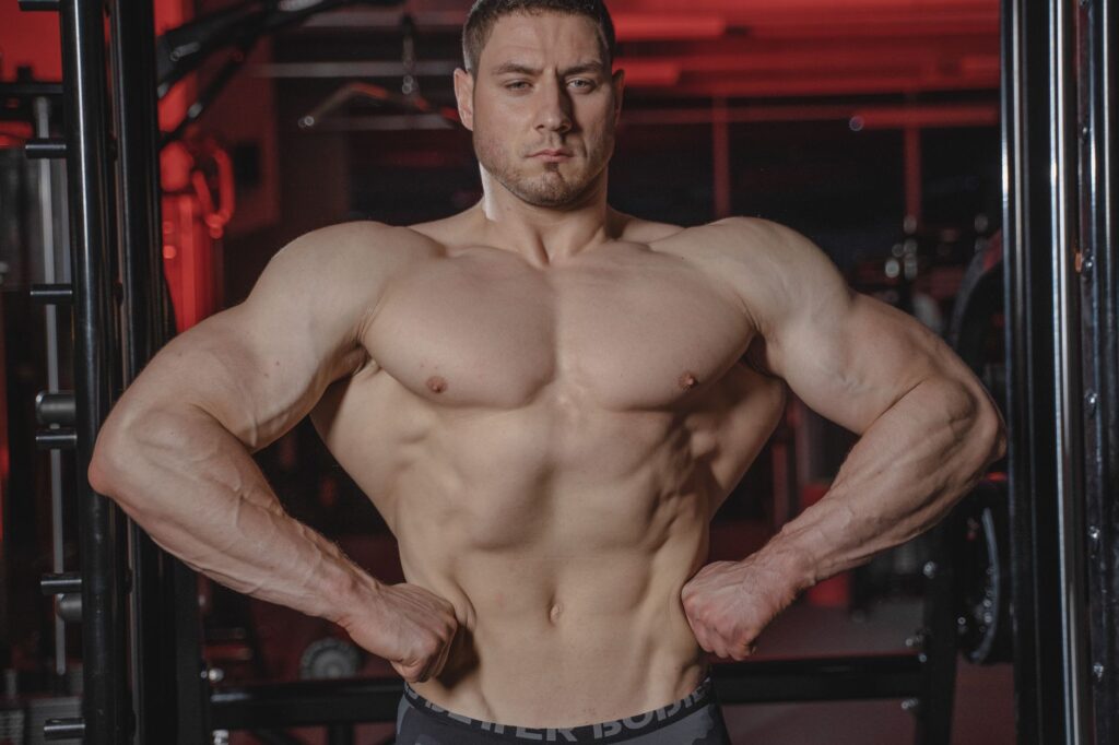 Trainer assessing client form during strength exercise